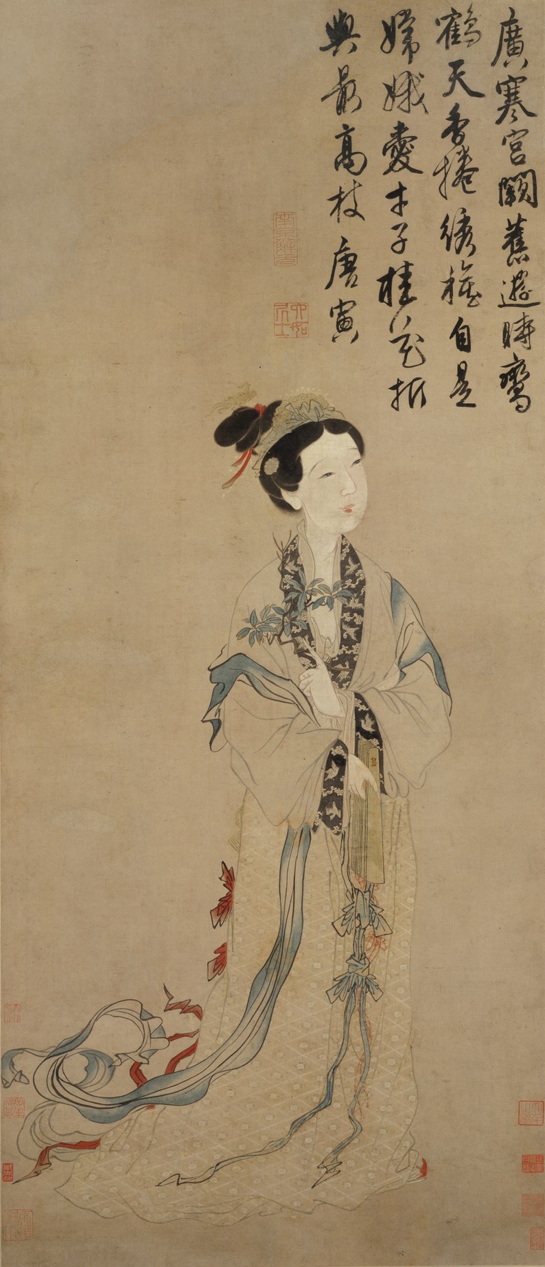 A Ming-dynasty hanging scroll of the moon goddess Chang'e as a single standing figure in pale flowing robes with long trailing sleeves and sashes, an elaborate jewelled coiffure, holding a sprig of cassia at her breast; a running colophon in cursive script fills the upper field.
